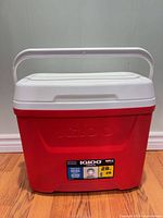 Front view of red Igloo Laguna 28 cooler with handle up