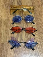 four assorted sunglasses pairs laid out vertically