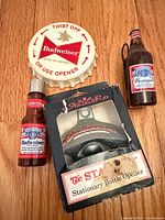 Overview of all four Budweiser items on wood floor