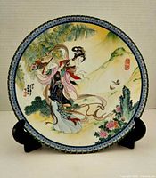 Front view of decorated porcelain plate on stand