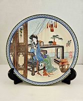 Front of plate showing detailed multicolour scene and patterned rim