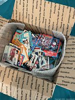 Top view of open box filled with assorted baseball cards