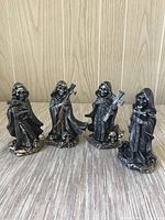 Group shot of four Grim Reaper figurines