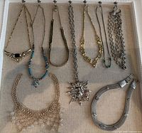 Overview of ten necklaces displayed on board