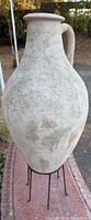 Full view of amphora on iron stand