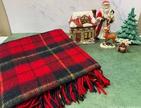 All items grouped: plaid throw, Santa, cottage box, reindeer, tree, small holder