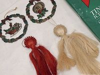 Front view showing two brass wreath ornaments, two fiber angels and tinsel package