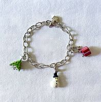 Entire bracelet with three enamel holiday charms visible