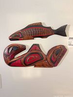 Front view of both carved wooden wall art pieces mounted on wall