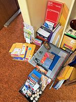 Overall lot showing trimmer, envelopes, mailers, notebooks, batteries, scissors, tape