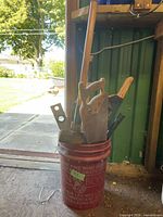 Bucket holding various hand tools