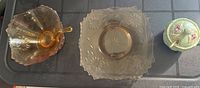 Three main items: amber bowl with ladle, square plate, ceramic covered pot