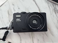 Front view of Vivitar VECXX99 camera showing lens and 4K marking