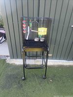 front view of black bird cage on wheeled stand