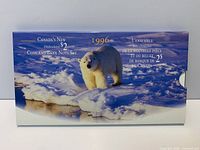 Front of closed presentation sleeve showing polar bear graphic and bilingual title