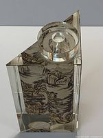 Top view of bottle showing round opening and triangular slanted top plus inner scroll