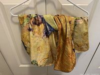 Scarf draped on hanger showing overall color and fabric texture