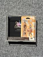 Overall lot showing sealed keychain blister and empty soundtrack jewel case