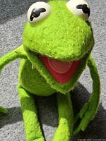 Full view of Kermit the Frog plush sitting upright