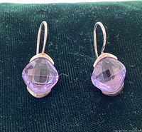 Front view of both silver drop earrings showing cushion-cut amethysts