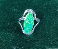 Front view of sterling silver ring with oval crystal opal cabochon