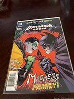 Front cover of the bagged Batman and Robin #16 comic