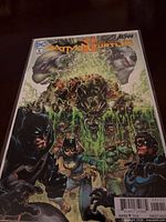 Front cover of Batman/Teenage Mutant Ninja Turtles #5 in bag with board