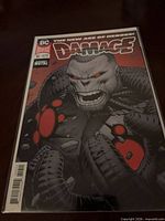 Front view of bagged Damage #10 comic showing full cover art