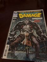 Front view of Damage #9 comic in bag and board