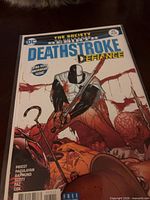 Front cover of bagged Deathstroke #25 comic