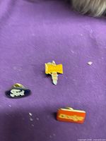 Three enamel automotive lapel pins Ford oval, Dodge rectangle, Champion spark plug