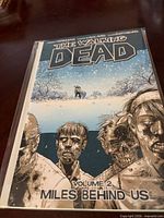 Front cover of The Walking Dead Volume 2 Miles Behind Us trade paperback