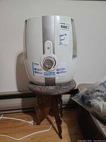Front view of HoMedics humidifier on carved stool
