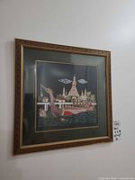 First framed embroidered Thai textile on wall