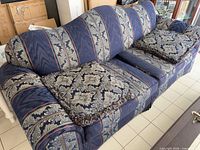 Front view of blue patterned 3-seat sofa with cushions