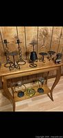 console table with candle holders and decor items