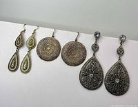 All three pairs of earrings laid out side by side