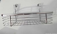 Front view showing chrome basket and attached over-cabinet hooks
