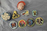 Group view of erasers, pogs and tin