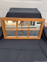 Front view of six-pane wood-framed mirror
