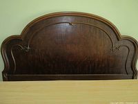Front view of arched wooden headboard