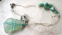 Full necklace showing sea-glass pendant, cord, beads, clasp