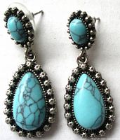 Front view of both earrings showing cabochons and metal settings