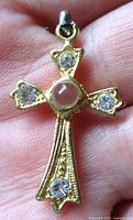 front view showing Stanhope lens, rhinestones, gold-tone detail