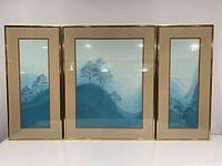 Front view of three framed prints forming triptych