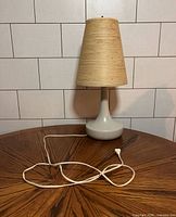 Full view lamp on table showing base, shade, cord