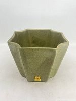 Overall view of green speckled hexagonal Haeger planter showing shape and color
