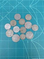 All coins arranged on mat to show quantity and size comparison