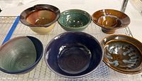 Group shot of all six handcrafted ceramic bowls arranged in two rows