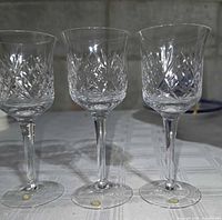 Three of the cut crystal wine glasses showing pattern and height